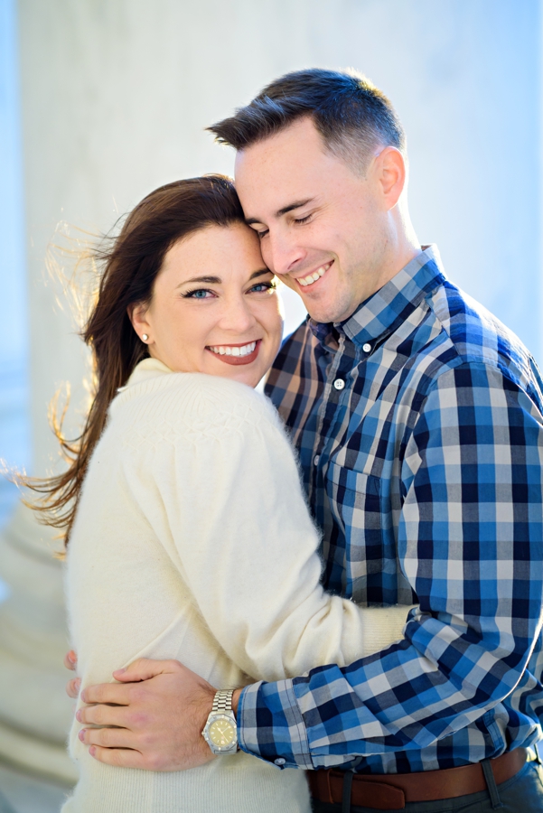 A cute couple hug in the warm light of the sunset in DC.